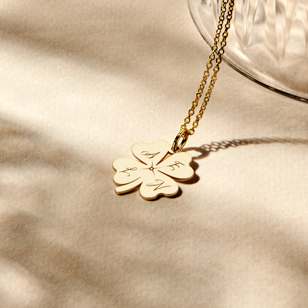 Gold cloverleaf pendant with initials