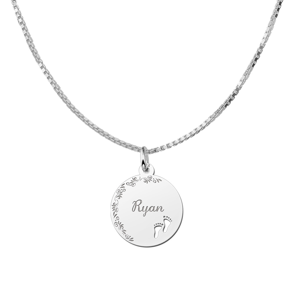 Silver pendant with floral edge and baby feet