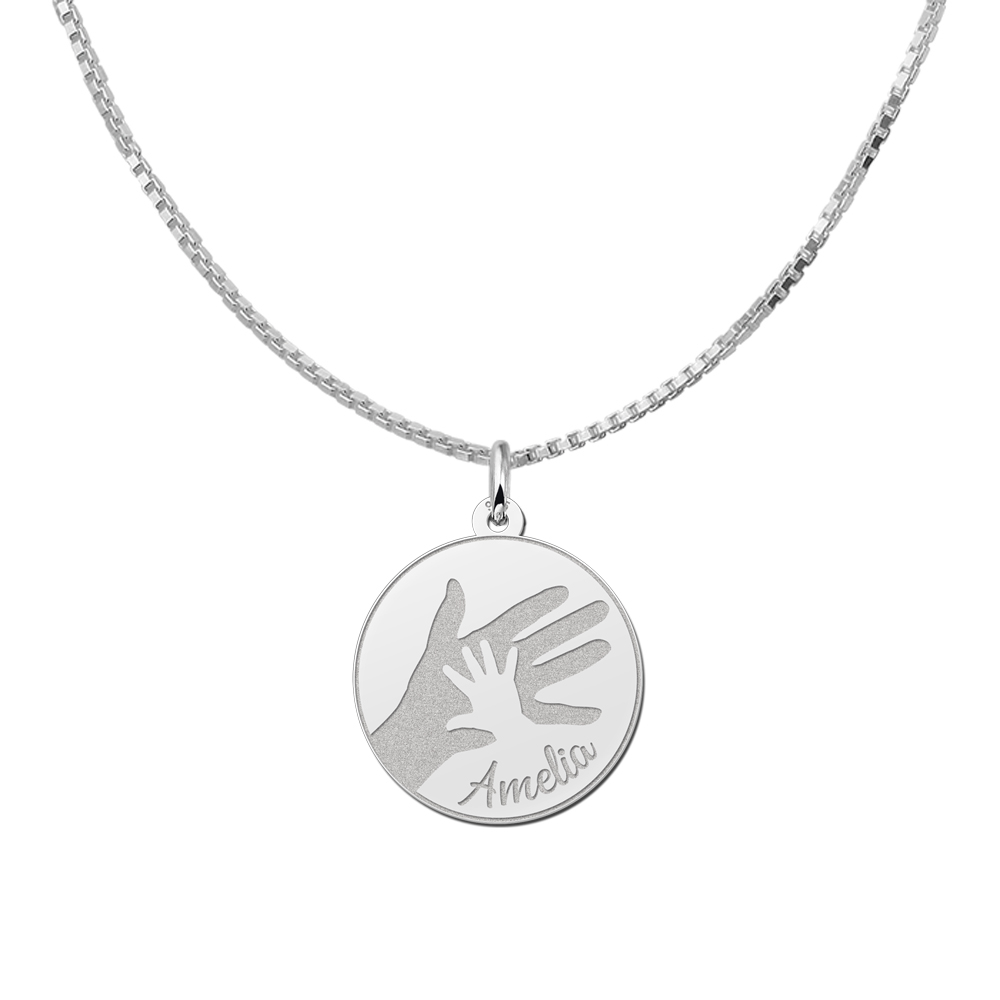 Silver round pendant with big and small handprint