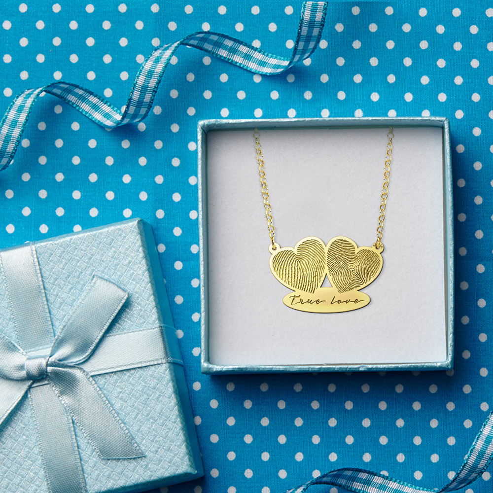 Gold pendant with two fingerprints and own handwriting