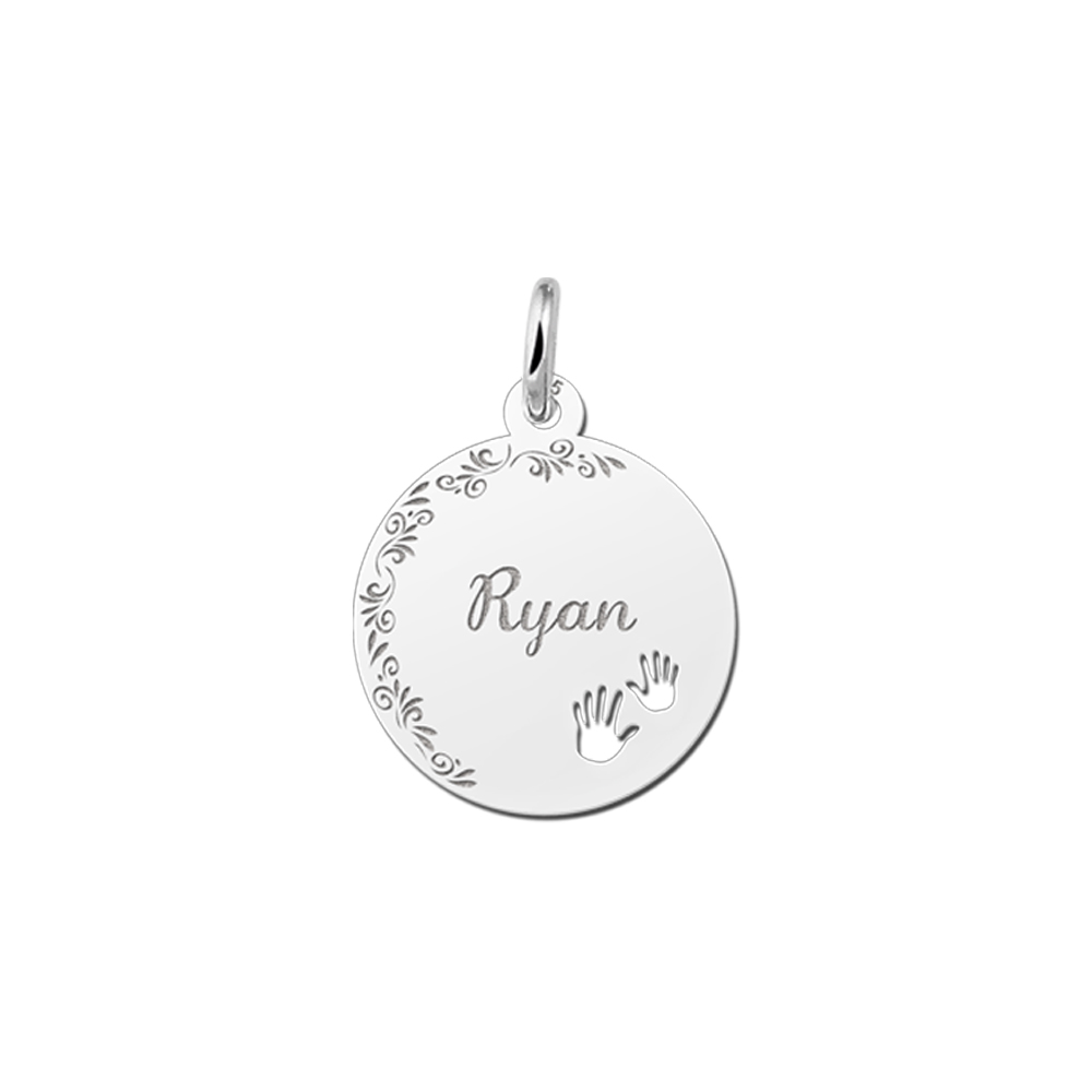 Silver pendant with floral edge and baby hands