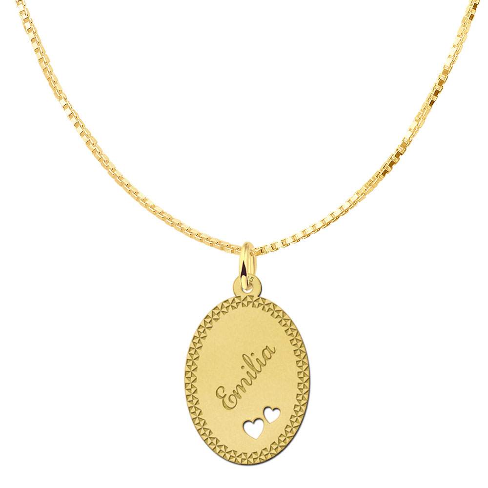 Gold-plated oval pendant with decorative border and two hearts