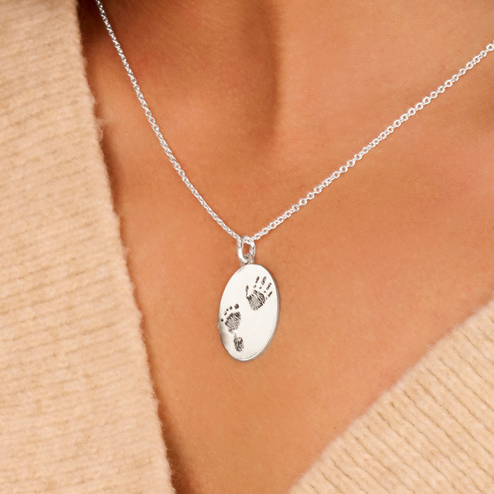 Silver oval pendant with full fingerprint