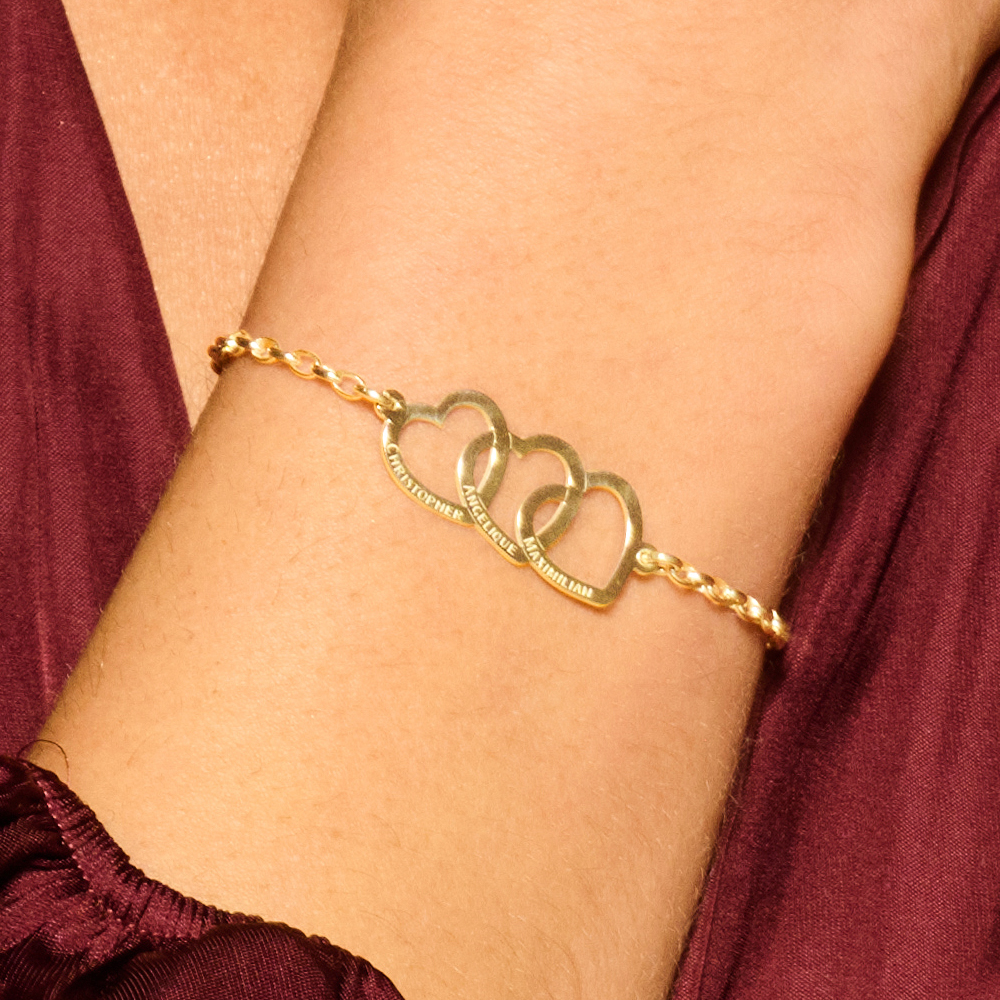 Gold bracelet with three linked hearts and names