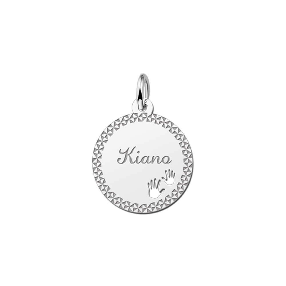 Silver pendant with decorative edge and baby hands