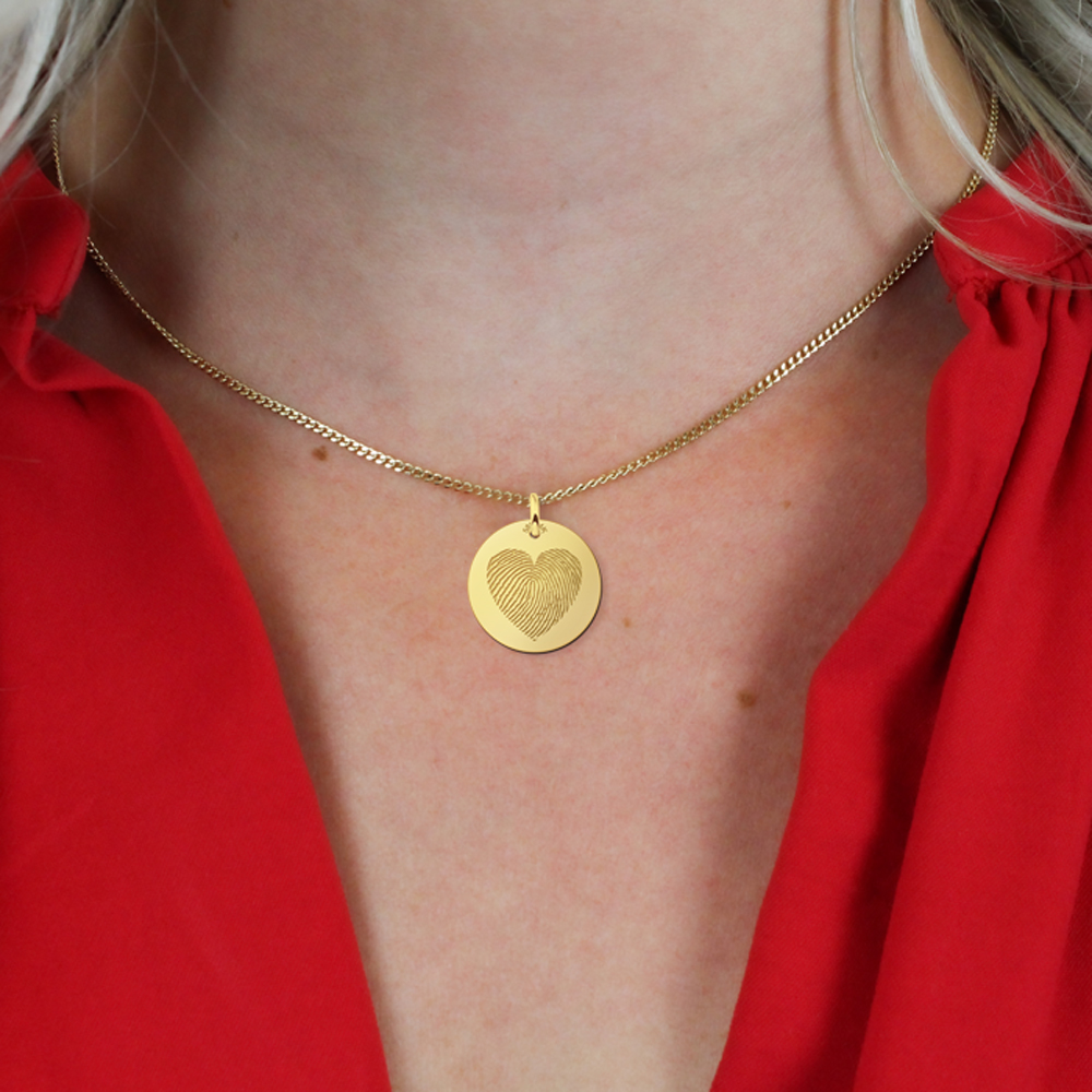 Golden pendant with fingerprint in heart shape