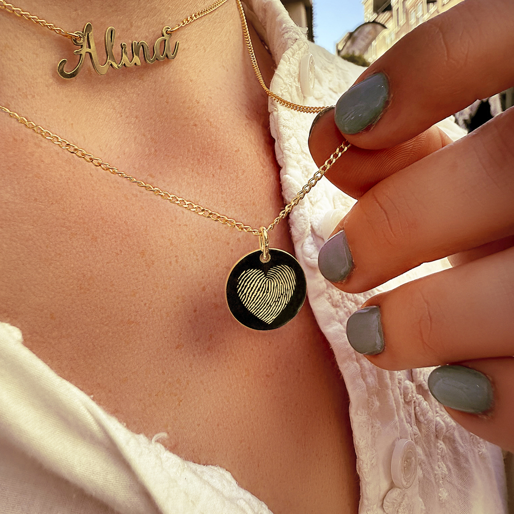 Golden pendant with fingerprint in heart shape
